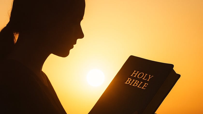 Silhueta de uma mulher lendo uma Bíblia ao pôr do sol: "HOLY BIBLE".