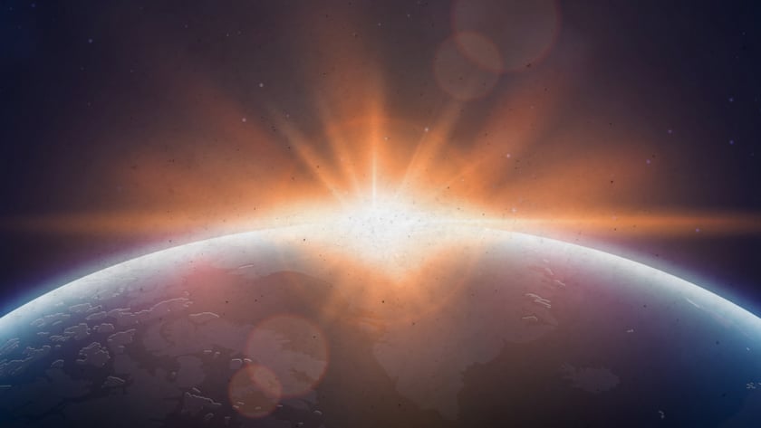Sol surgindo atrás da curva de um planeta, com estrelas no céu escuro.