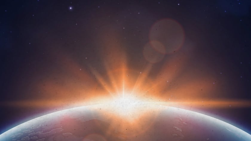 Sol surgindo atrás da curva de um planeta, com estrelas no céu escuro.