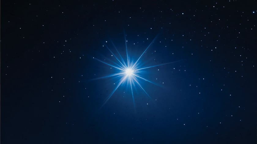 Estrela azul muito brilhante com raios longos, cercada por pequenas estrelas no céu escuro.